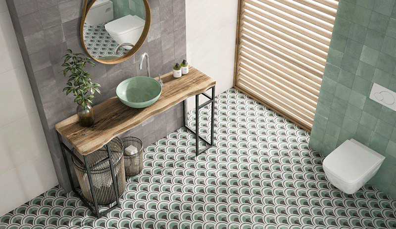 Cuarto de baño rustico con colores verde y gris con dibujo geometrico en el suelo